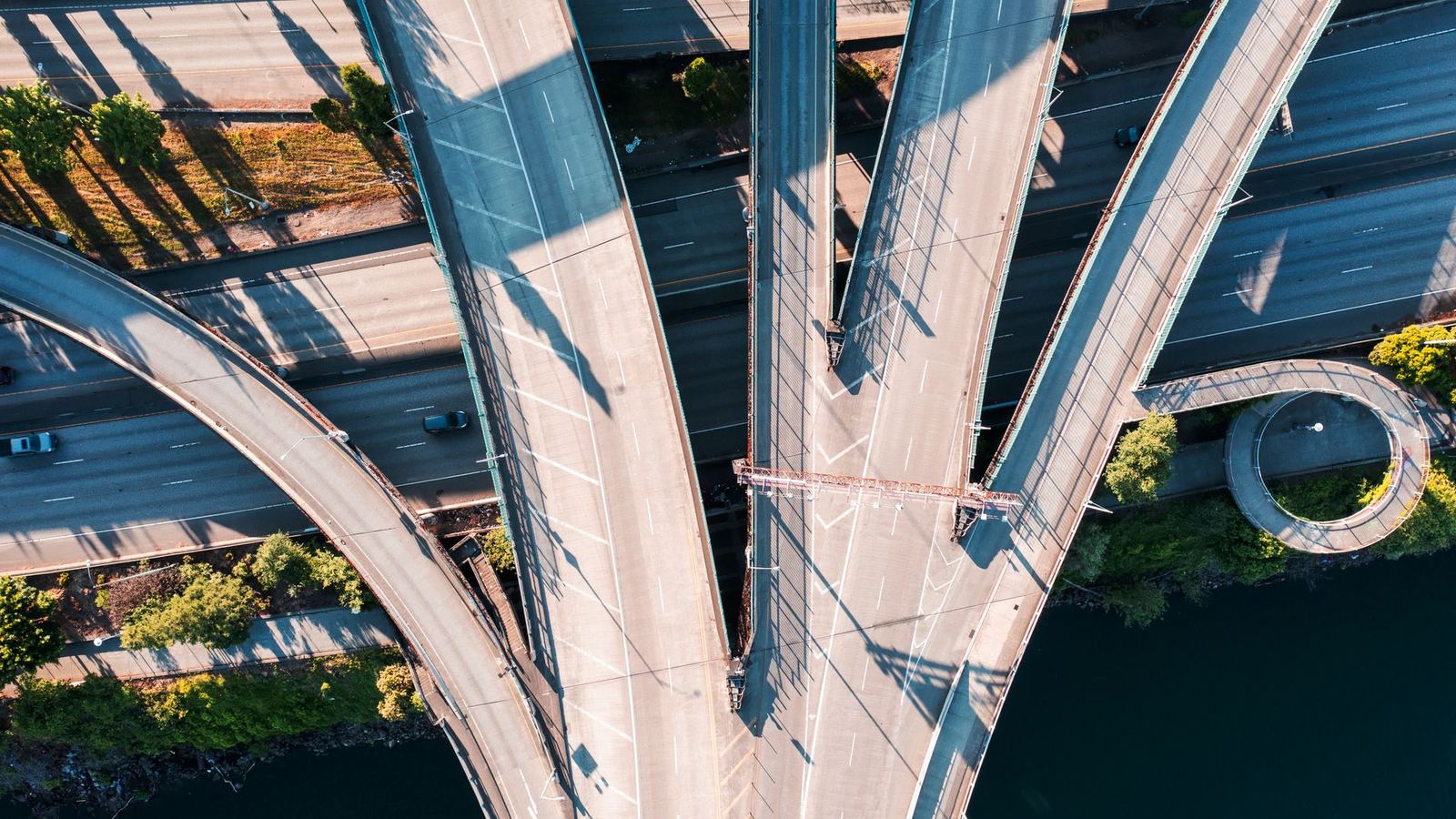 An aerial view of a highway interchange with roads curving in several directions