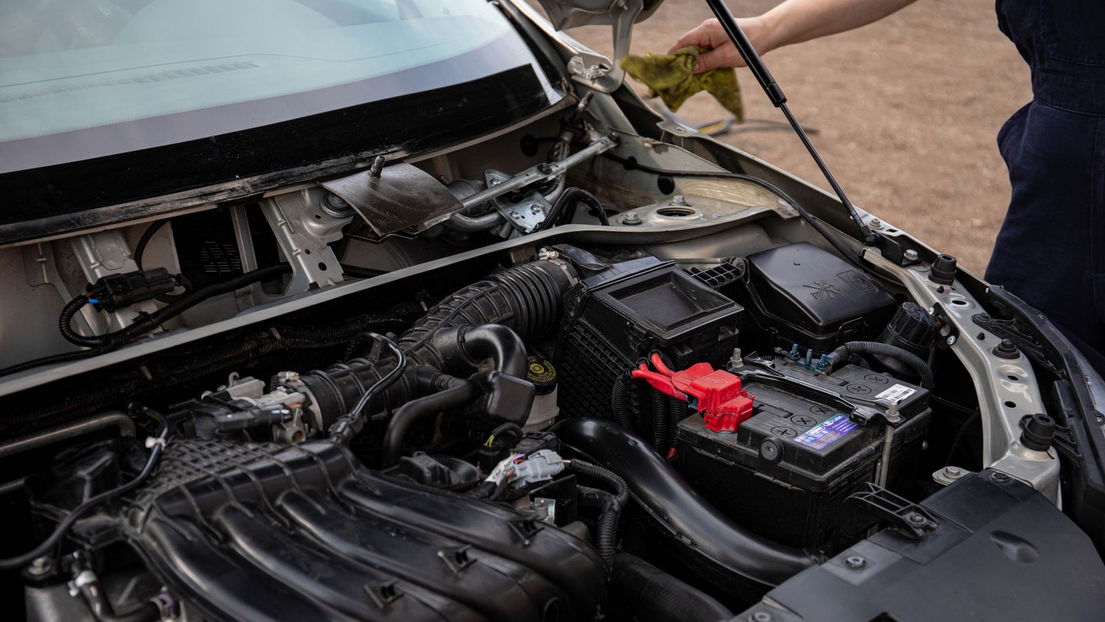 An open engine bay with the battery and cooling system visible