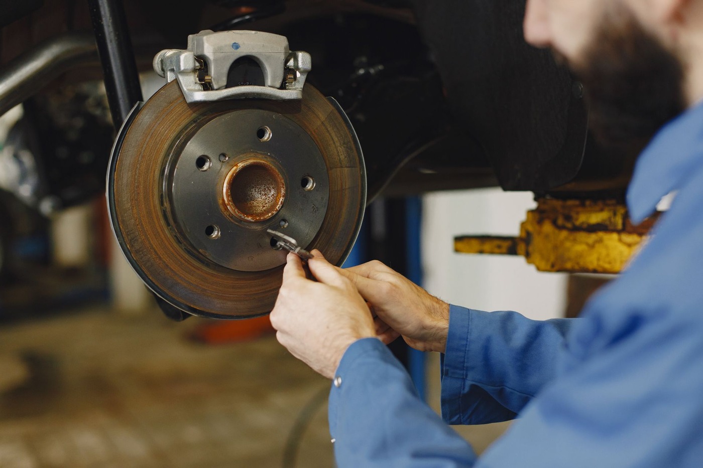 A brake rotor and hub with the wheel removed during a vehicle inspection